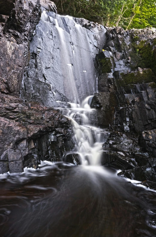 an upturned waterfall with clear water coming down from it