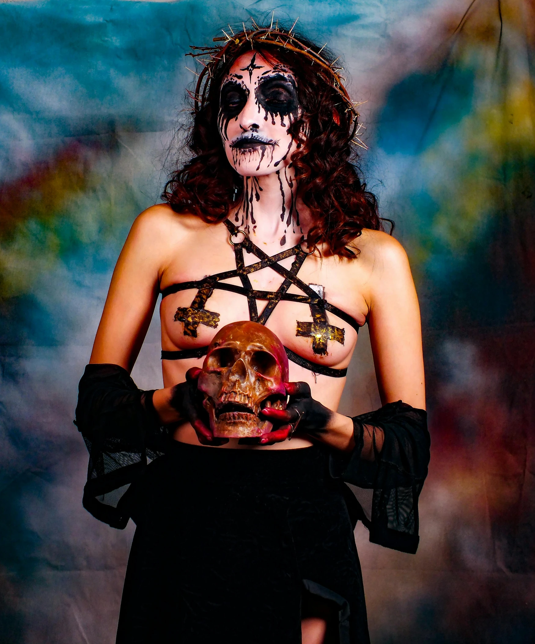 a lady that is holding a dead skull and crossbones