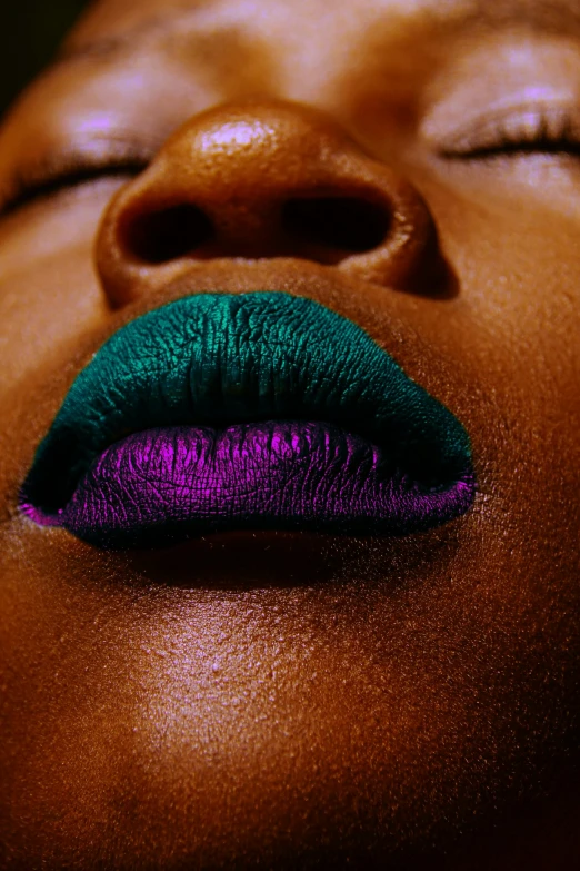 the lip of a woman with purple and green lipstick