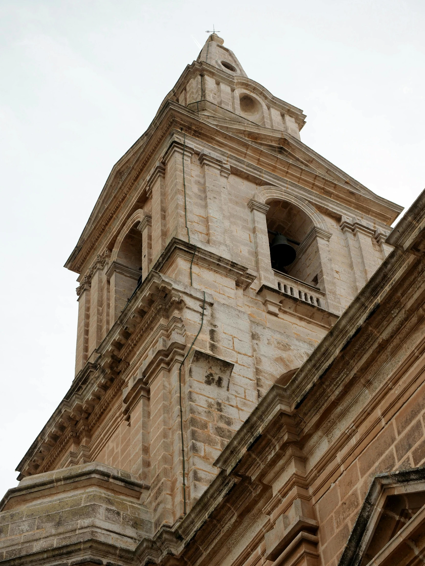 a building with a steeple and clocks on it