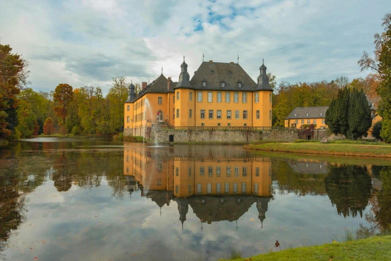 a castle and the lake on an autumn day