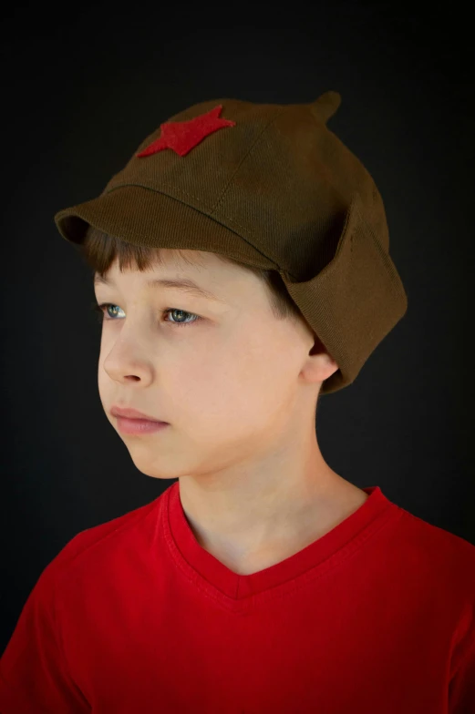 a boy in red shirt wearing a green hat