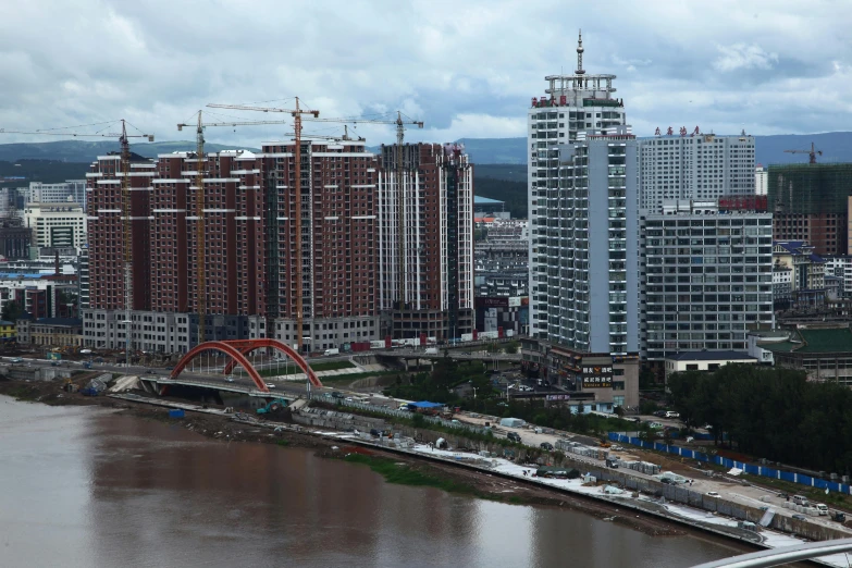 tall brown buildings surround a city river in the background