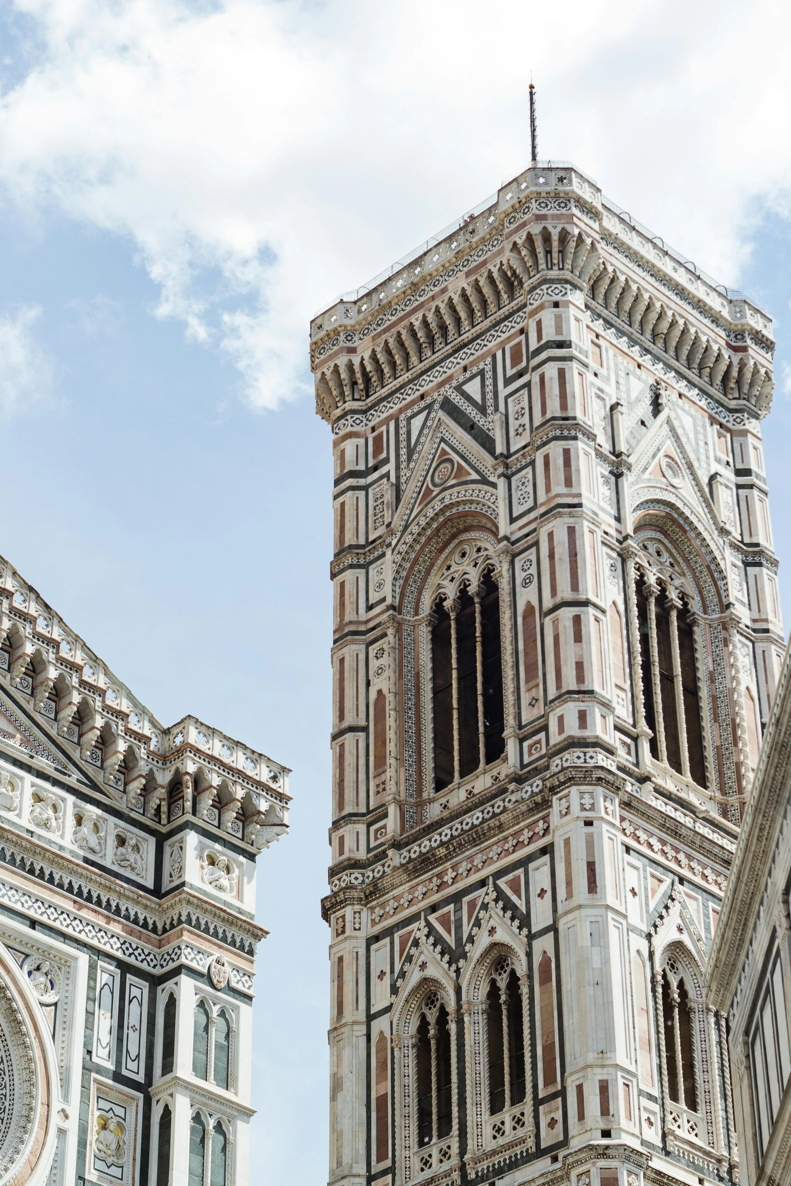 two towers with white walls and brown details on the sides