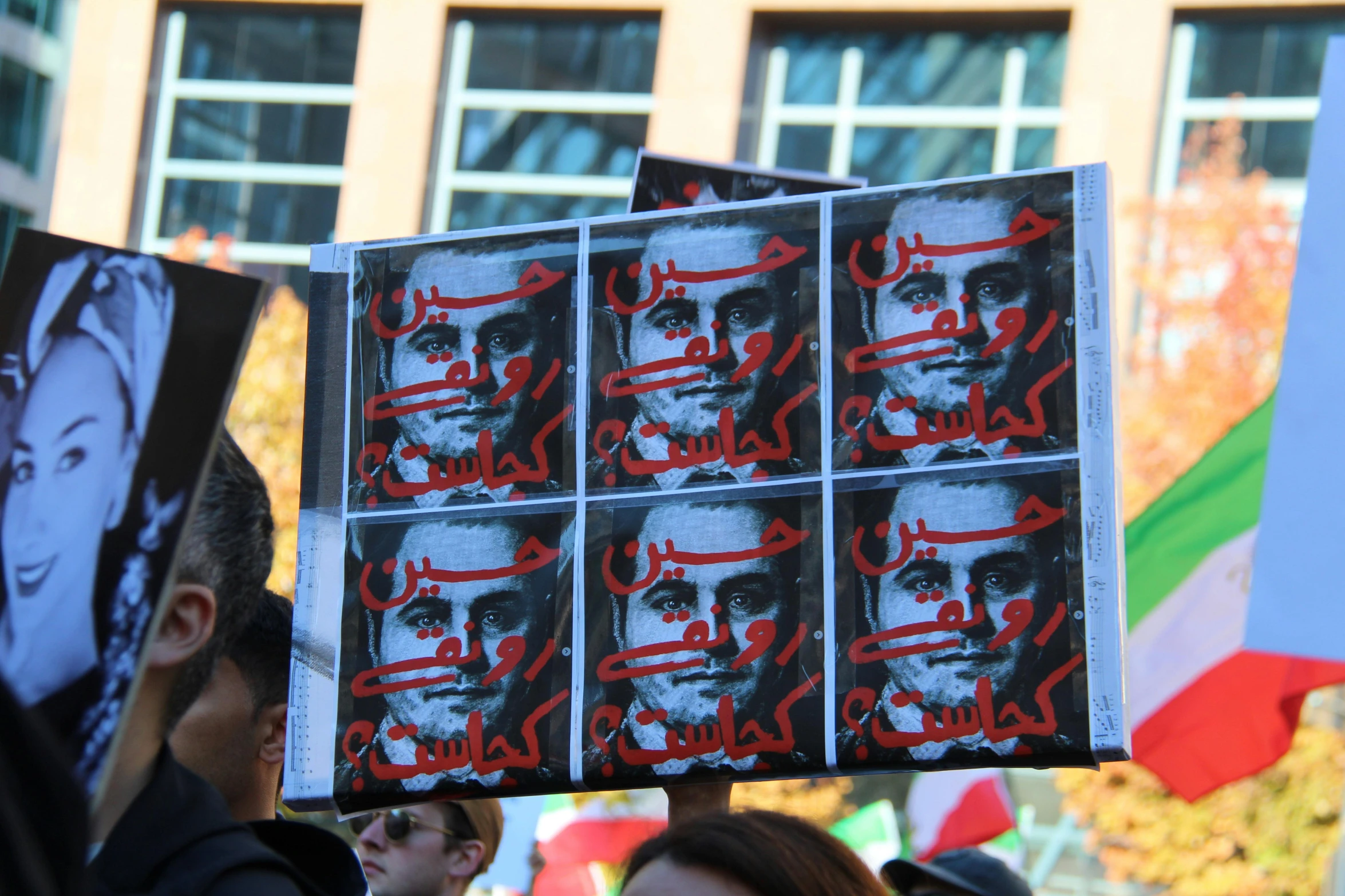 people are holding signs with the portraits of murdered murdered men