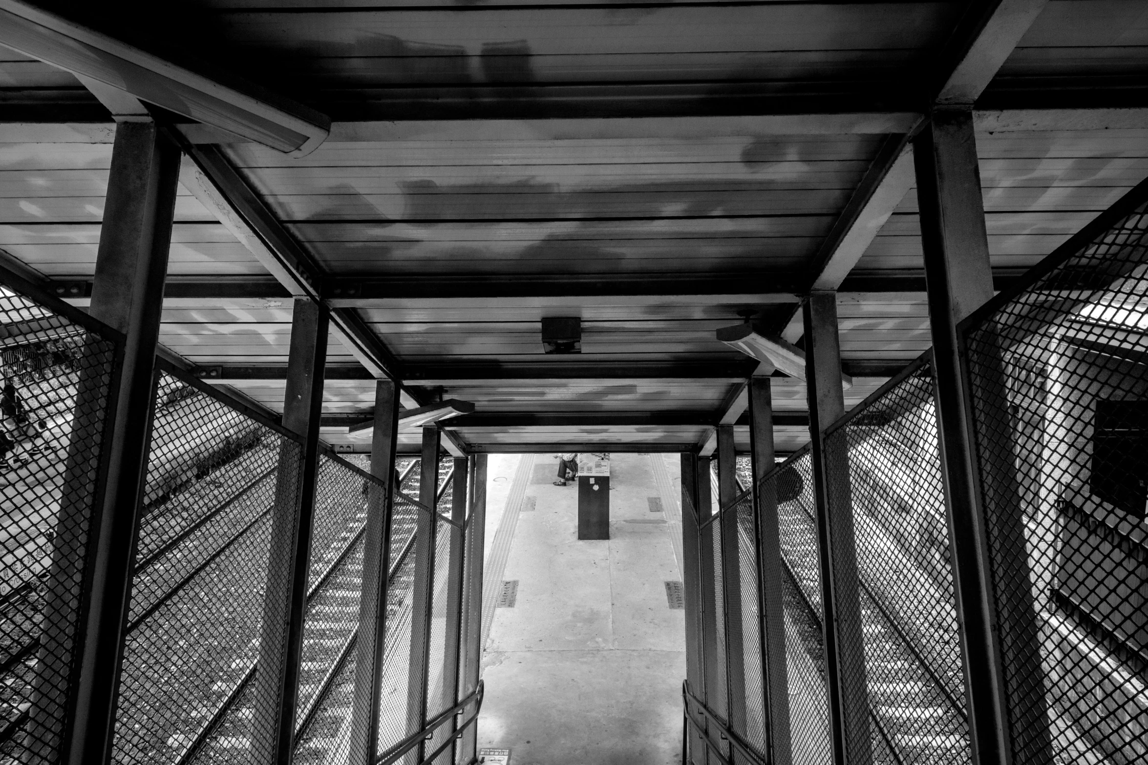 a line of gates leads up into a tunnel filled with prison wire