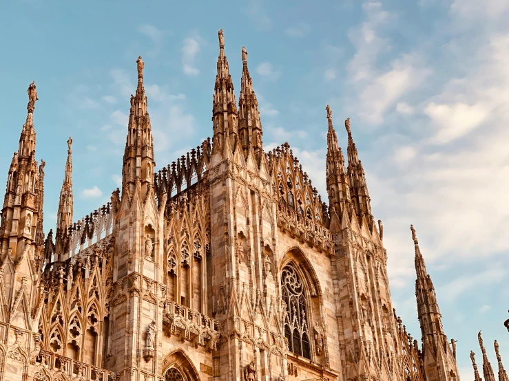 the sun shining on a very large cathedral