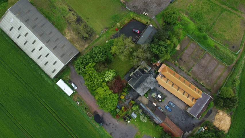 an aerial view of an old brick house in an area