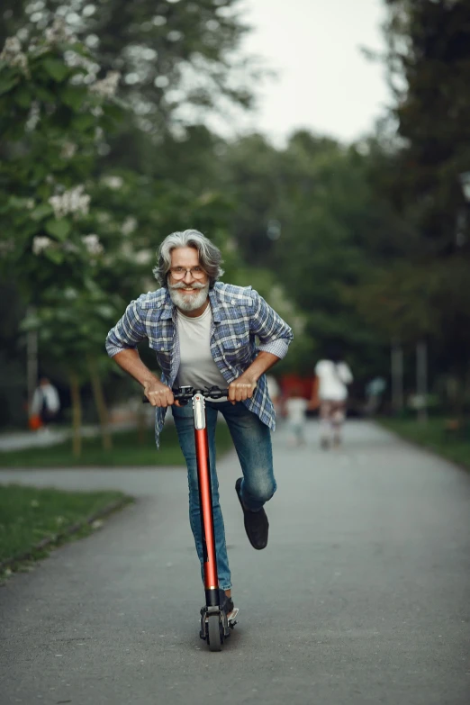 a man riding a scooter while holding on to his leg