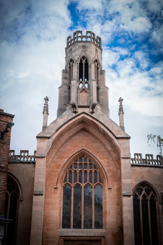 an old church with its tall steeple on a cloudy day