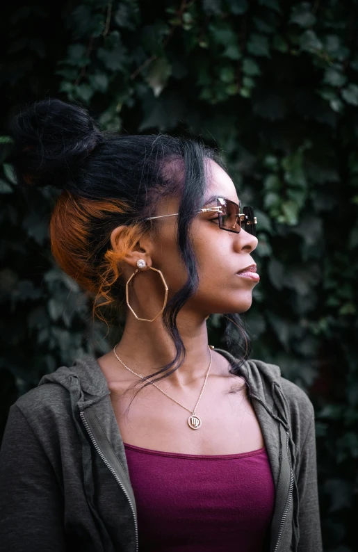 the woman has a large pair of gold hoop earrings in her ear