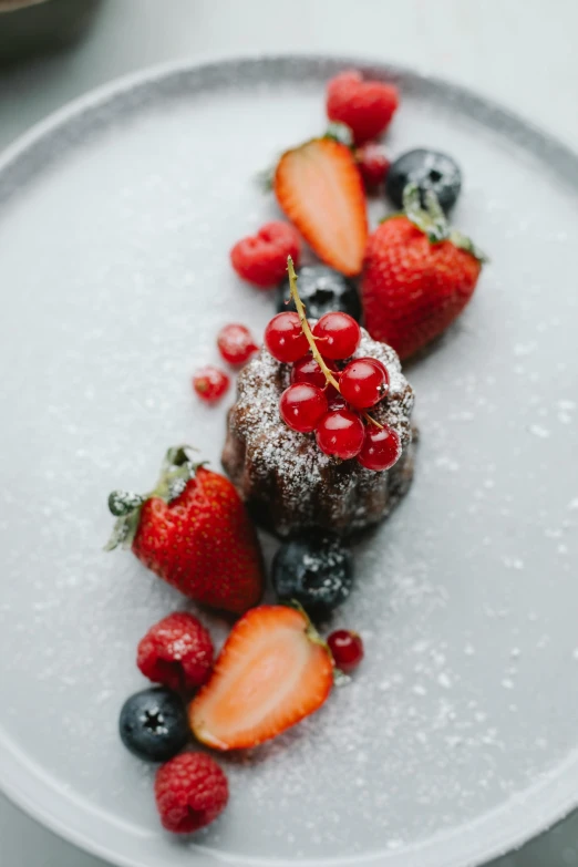 a white plate topped with dessert and berries