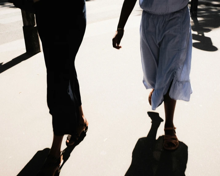 two people walking on a path holding hands