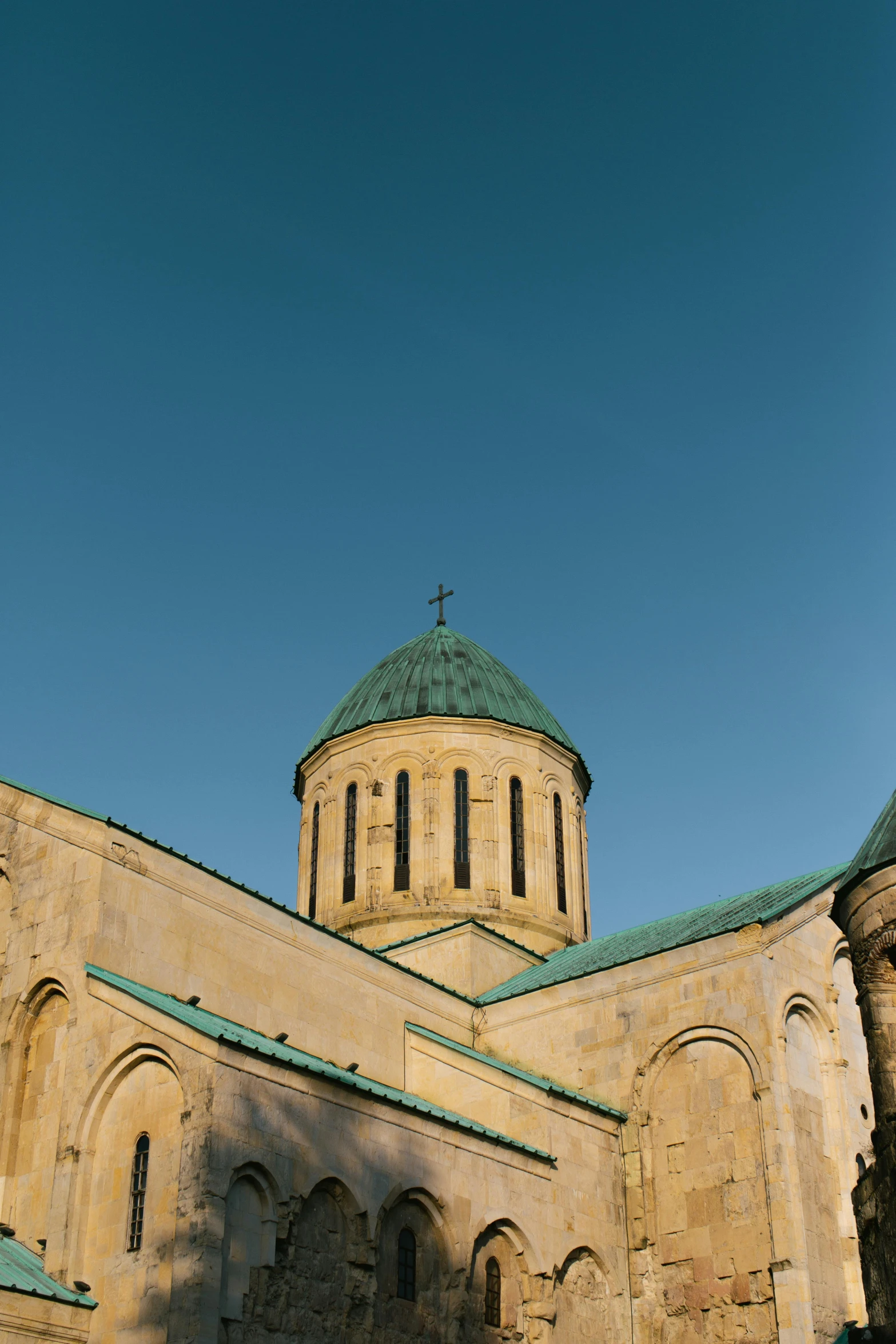 the large building has green roof and a cupola