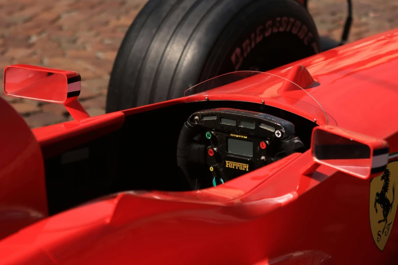 the steering wheel and instrument display inside of a race car