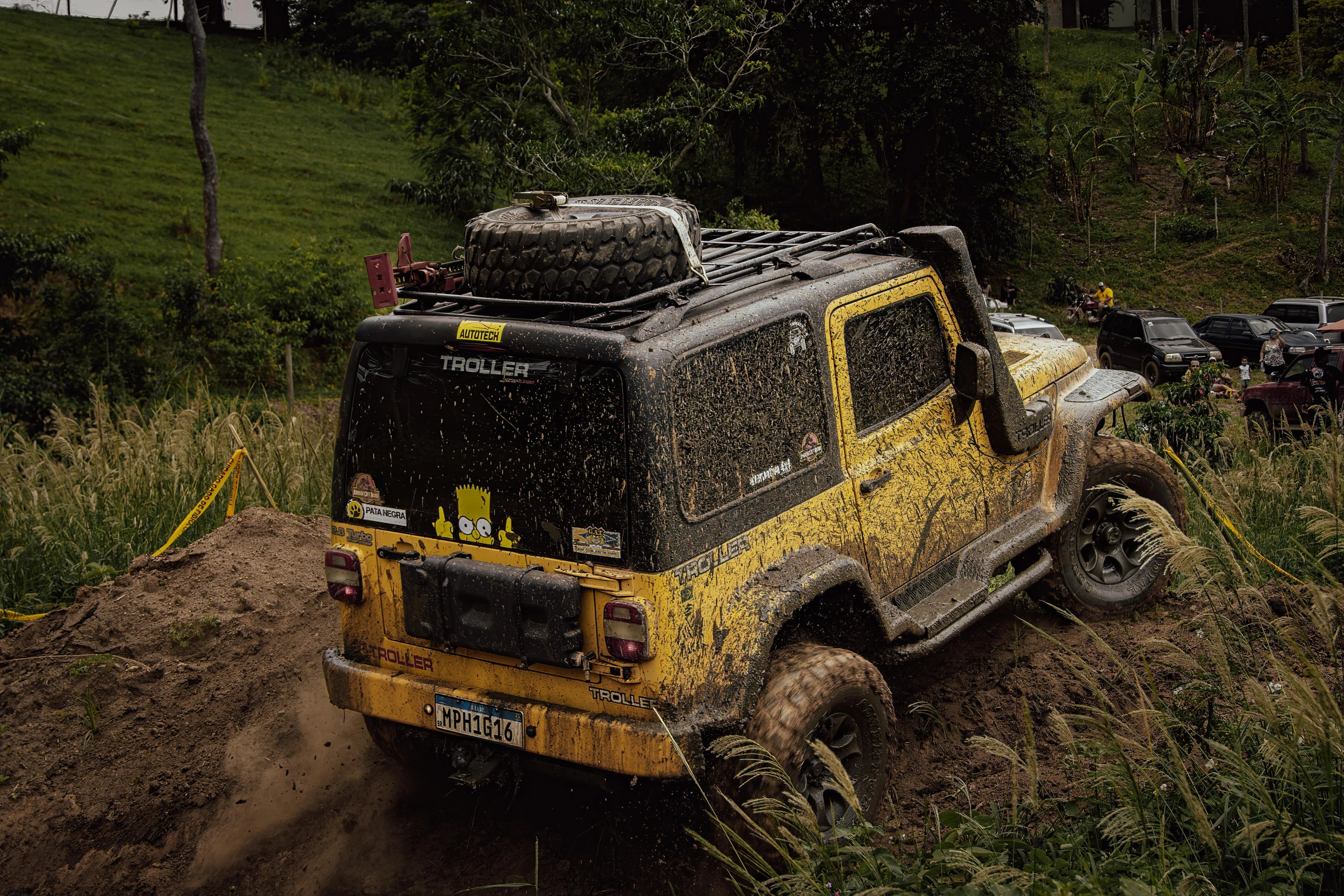 the mud is falling on top of a jeep