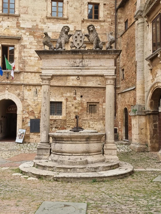 there is a statue on the ground in front of a stone building