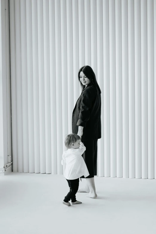 a woman holds her hand out to a child