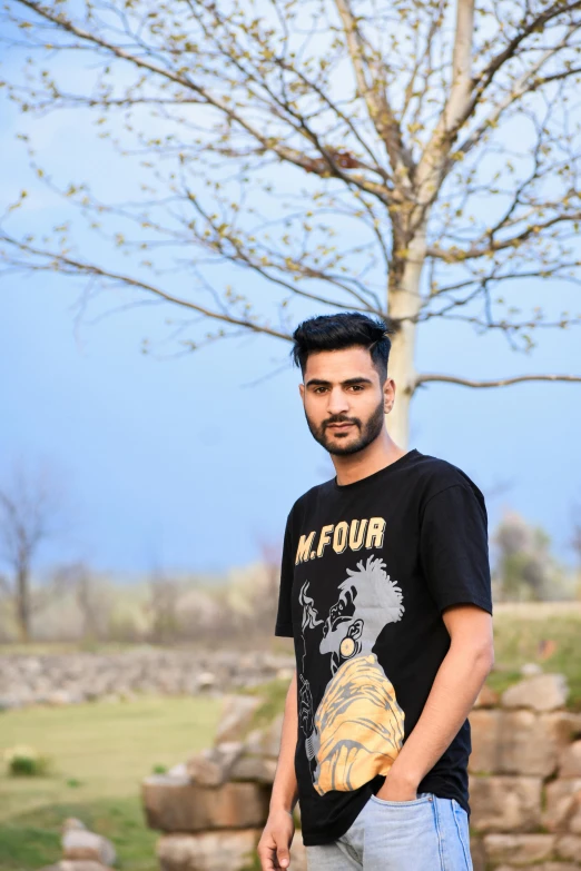 a man in a black t shirt and a tree