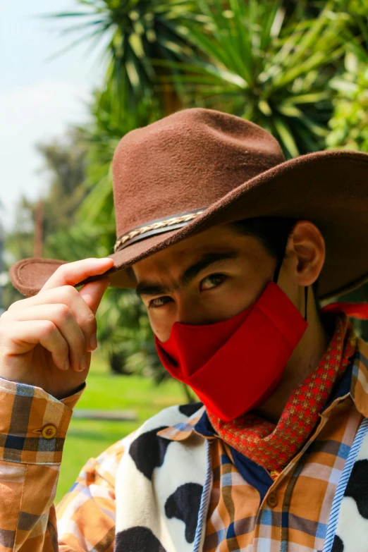 an asian man wearing a hat, bandanna and mask