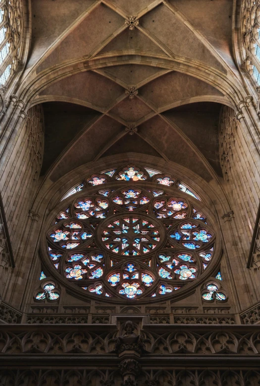 a large stained glass window inside of a cathedral