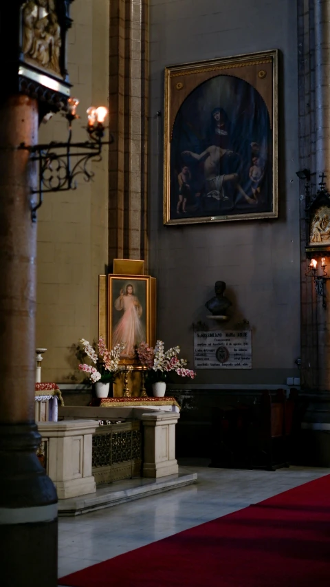 a shrine with a painting hanging on the wall