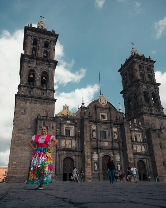 woman in colorful clothing near old style cathedral