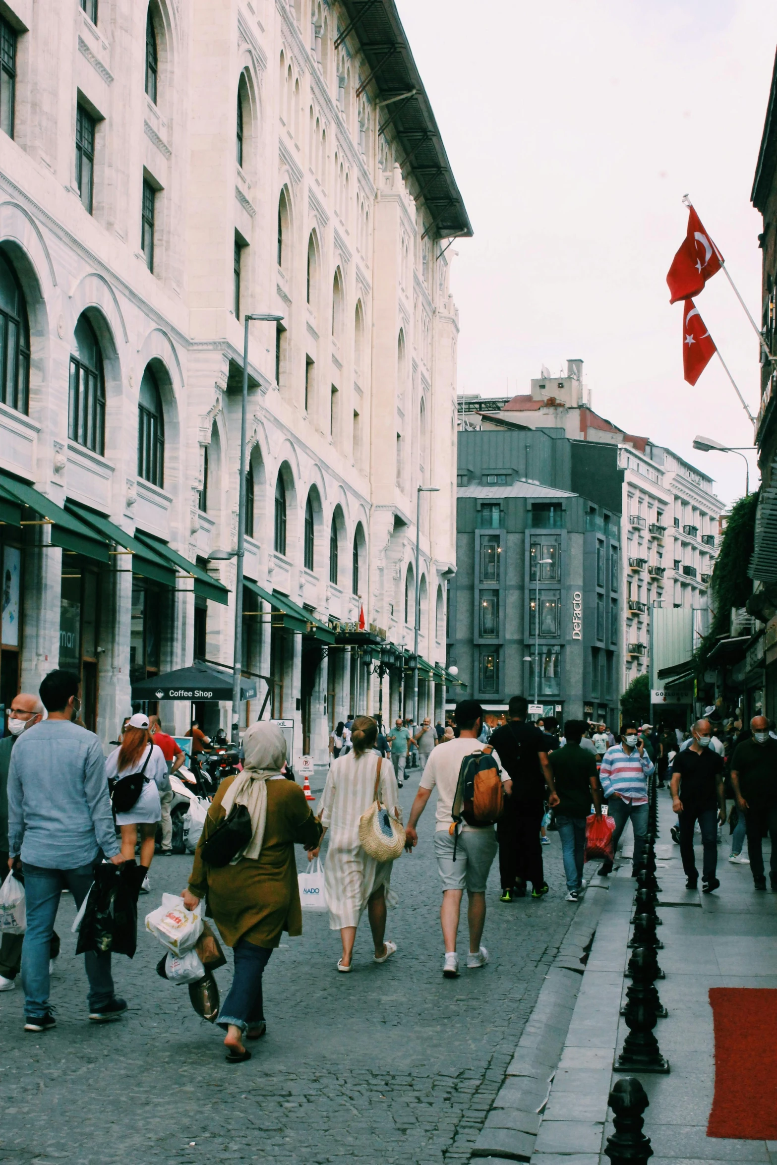 a group of people walking down a city street