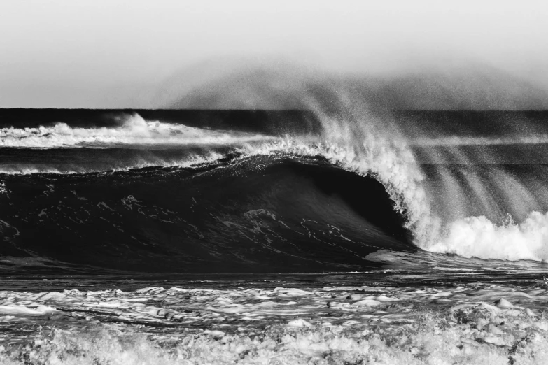 a huge wave rolling across the water