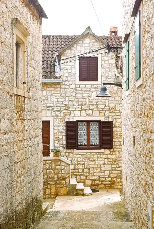 an alley leading to some brown and tan buildings