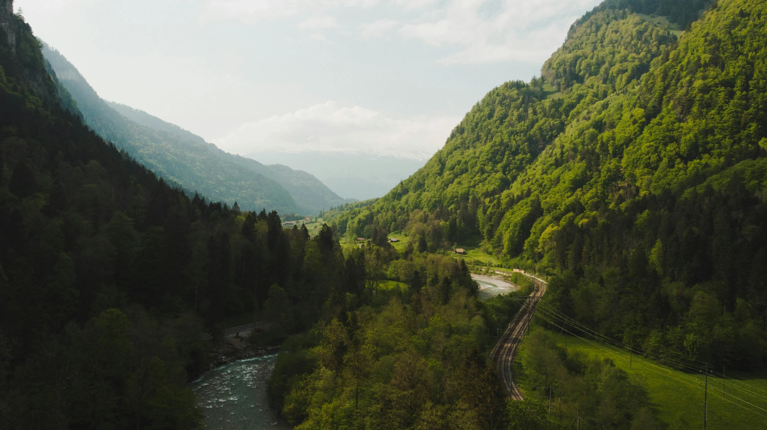 a river running between two mountain side sides