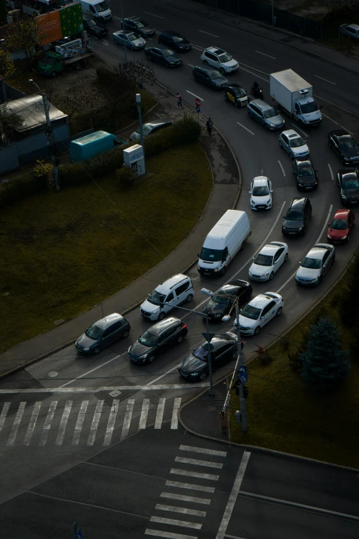 an overhead view of cars stopped at a street light