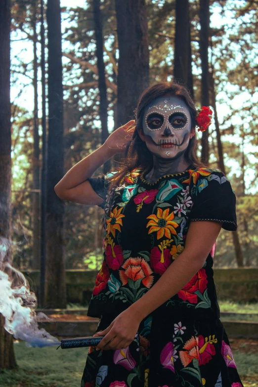 a woman dressed in day of the dead makeup