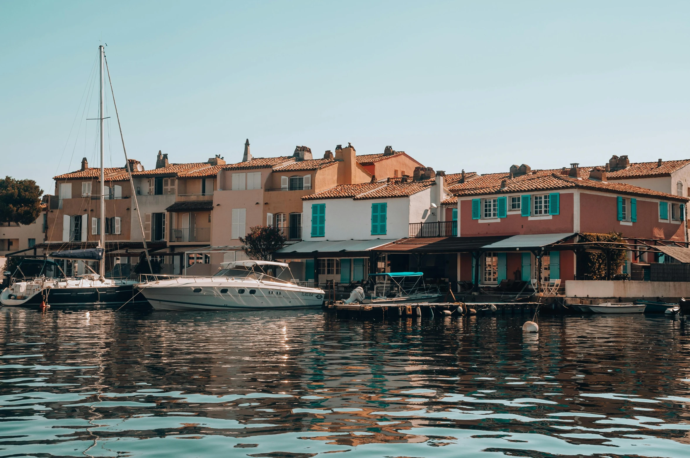 some boats docked on the side of a river