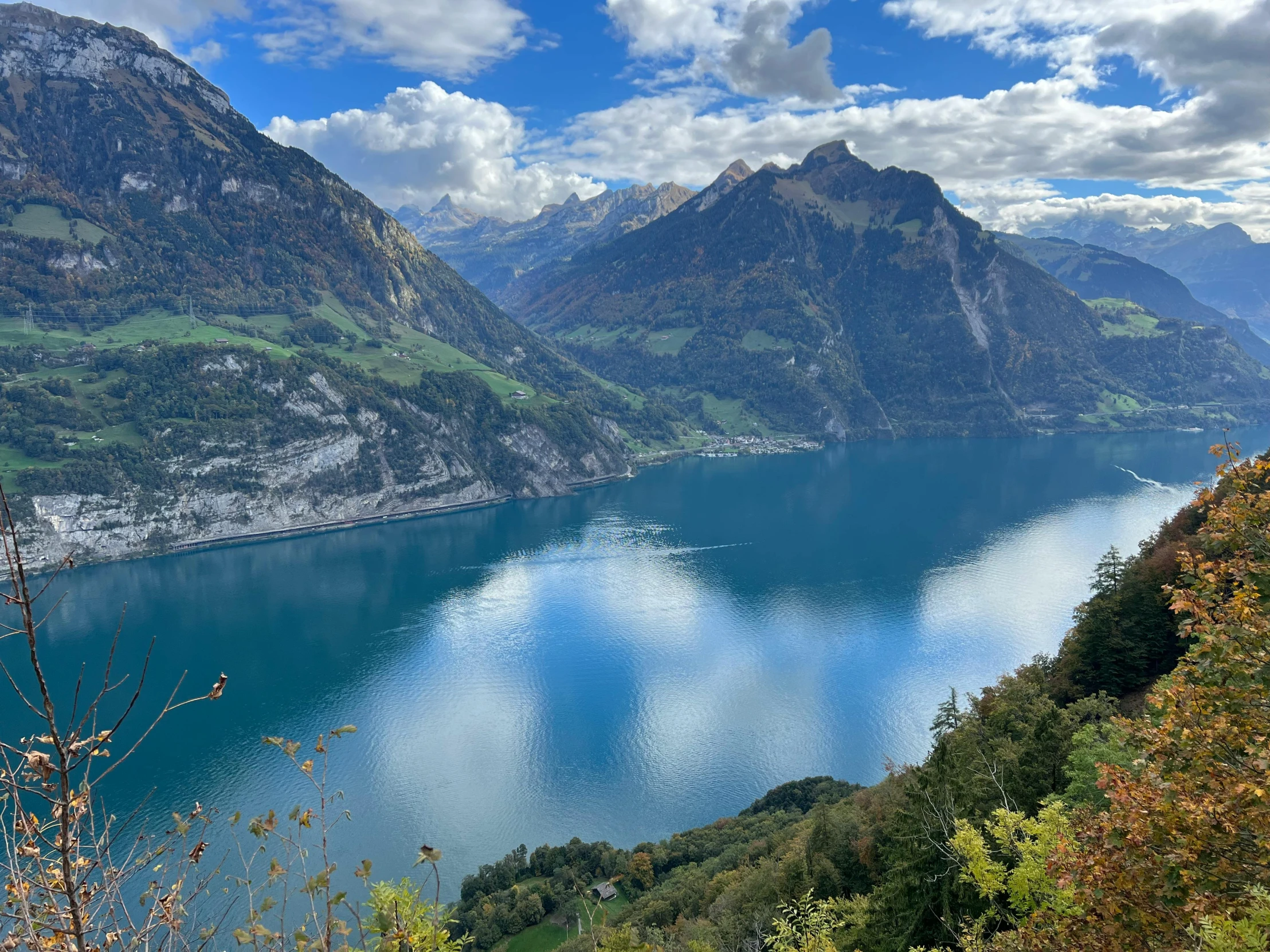 the mountains and water are covered by bright clouds