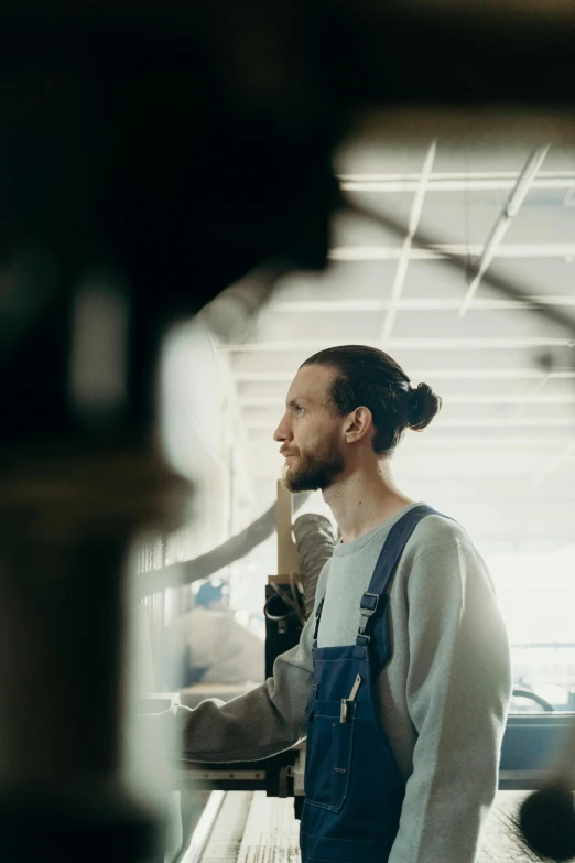 a man is standing at the airport and talking on his phone