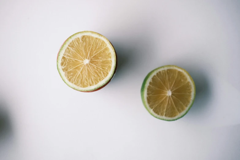 a lime is on top of another lime that is half