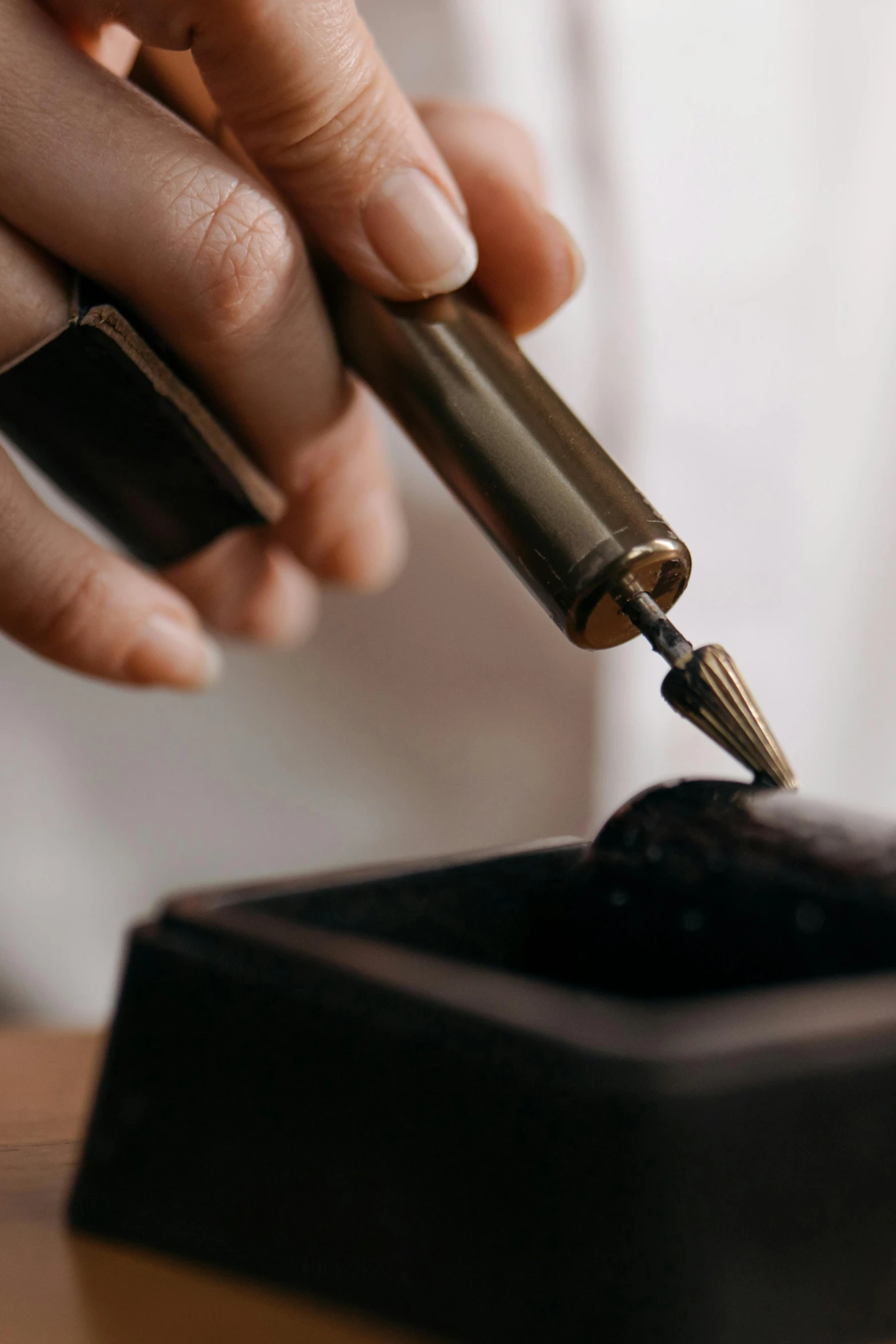 a close up of a person preparing a pipe