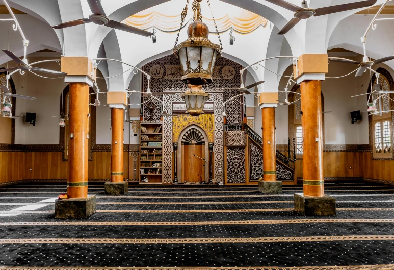 an empty church with some columns and a light fixture