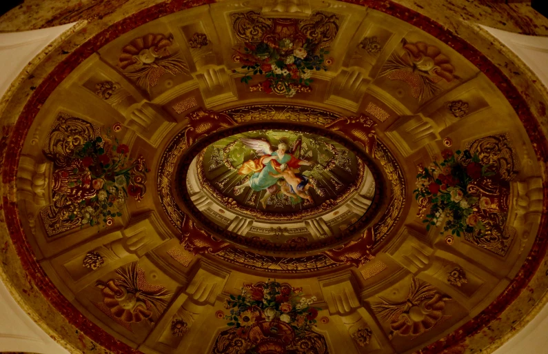 the ceiling in this church has beautiful gold and red design