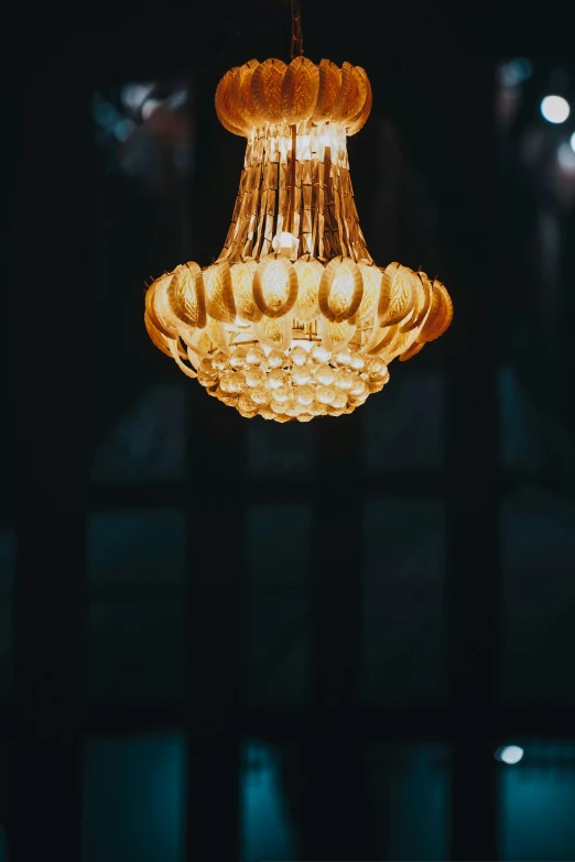 a lit chandelier hanging from a ceiling in a room