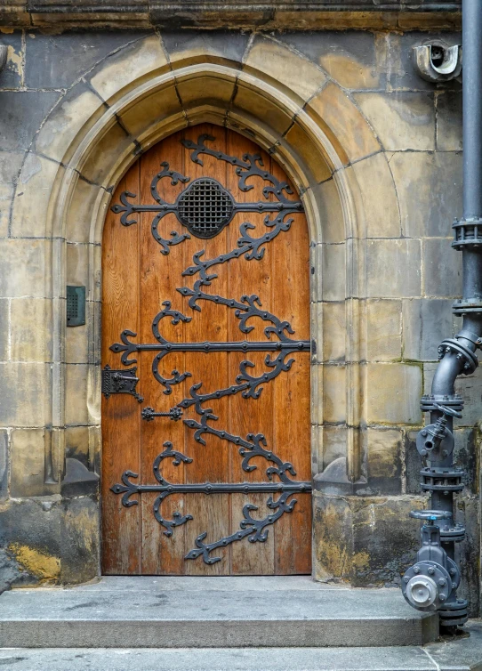 a wood door with metal parts in the center