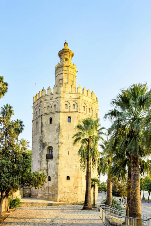 a large tower sitting next to palm trees