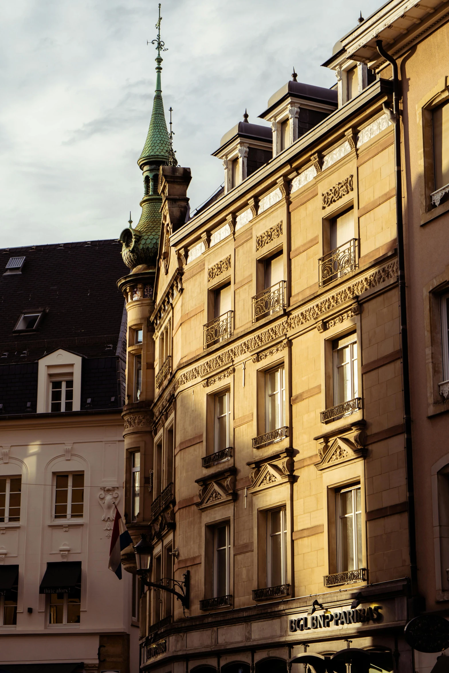 several different buildings with many windows and a light on them