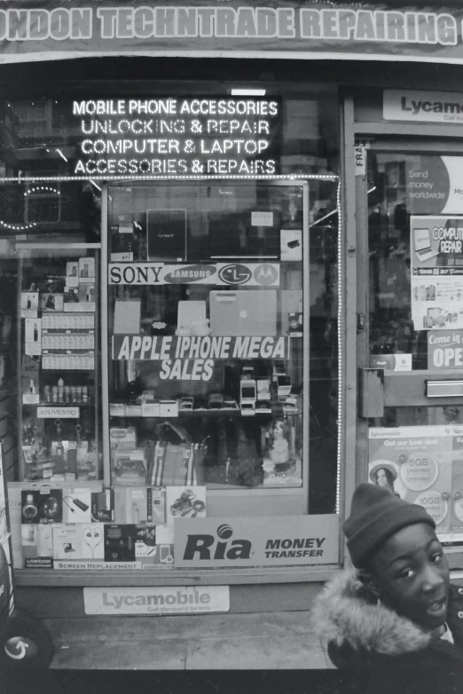 a man on a phone looking at a store