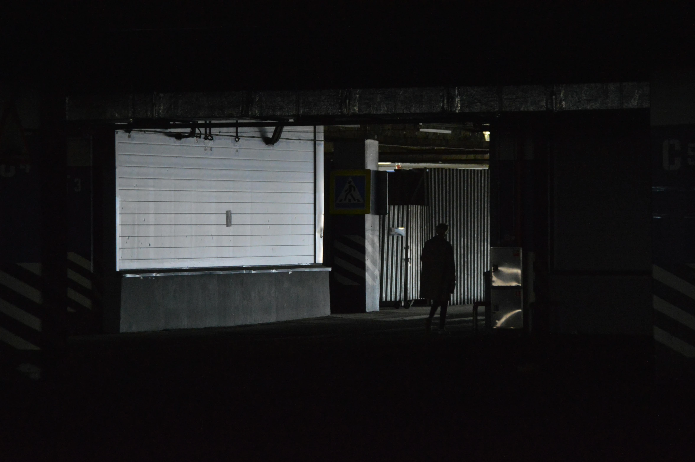 a dark po of a man standing in front of the door