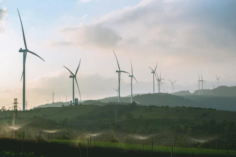 a group of windmills are standing near each other