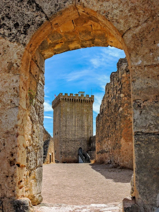 a castle with arches and a walkway leading into the building