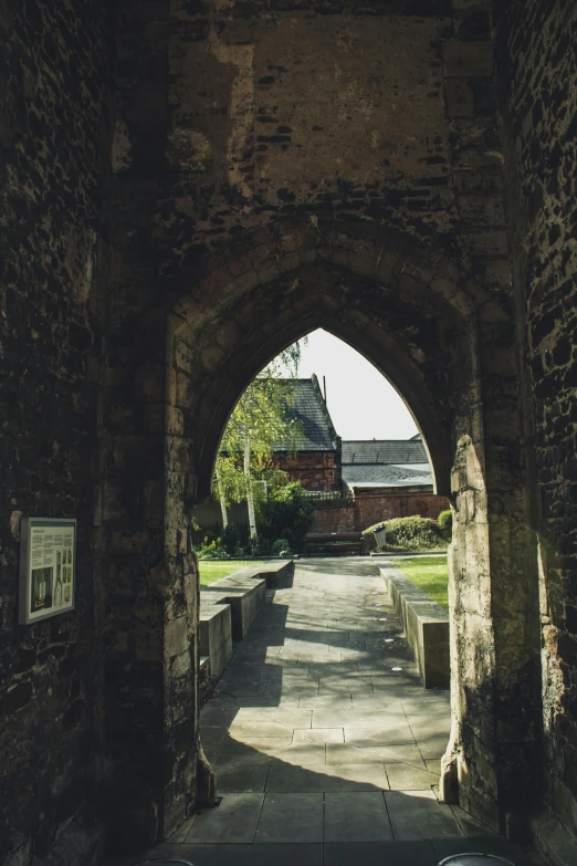 a tunnel going through the cement with benches under