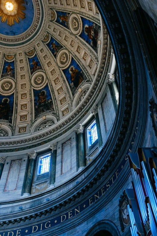 there is a cathedral ceiling with paintings in it